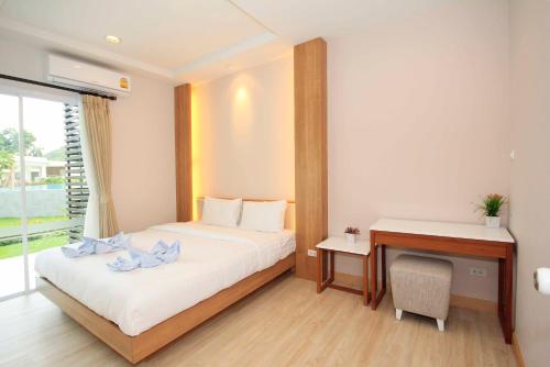 a hotel room with a bed and a desk at The Sea Condominium A16 @ Dophin Bay, Pranburi in Ban Nong Khaem