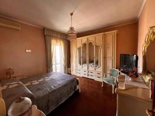 Un dormitorio con una cama y un televisor. en The green house, en Roma