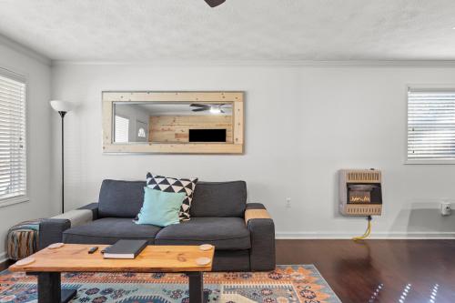 a living room with a couch and a table at Grey Duck in Beattyville