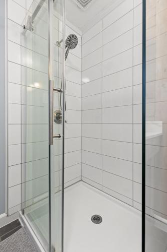 a shower with a glass door in a bathroom at Grey Duck in Beattyville