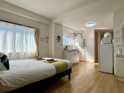 a hospital room with a bed and a refrigerator at nestay apartment tokyo kagurazaka in Tokyo