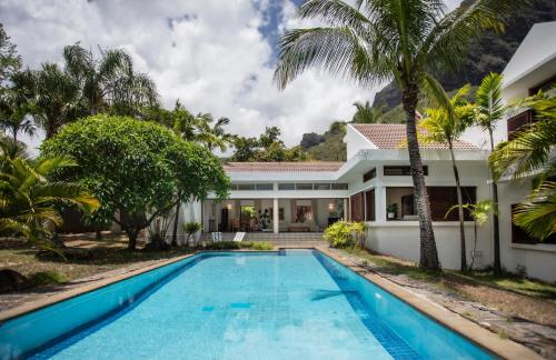 an exterior view of a villa with a swimming pool at The Villa - Le Morne - Kite, Golf & Beach in Le Morne