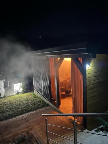 a house with an open door at night at Domek w dolinie in Berest