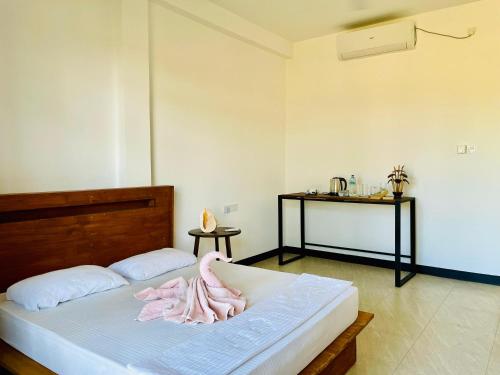 a bedroom with a bed with a towel on it at Tranquil Sanctuary Yala in Tissamaharama