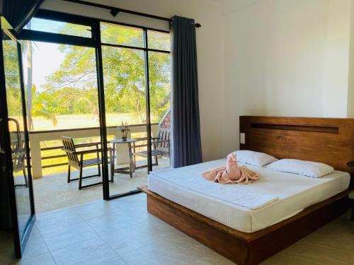 a bedroom with a bed with a towel on it at Tranquil Sanctuary Yala in Tissamaharama