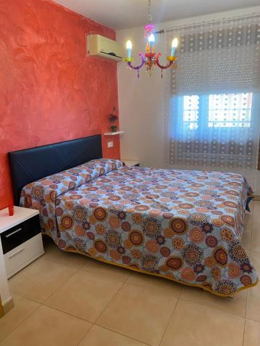 a bedroom with a large bed with a colorful bedspread at Residencial Algaida in Oropesa del Mar