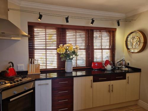 a kitchen with a vase of yellow flowers on a counter at 3onPacific in Sedgefield