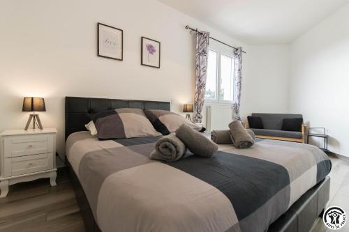 une chambre avec un grand lit avec des serviettes dessus dans l'établissement Les Villas de Castel - Villa Les lauriers, à Castelmaurou