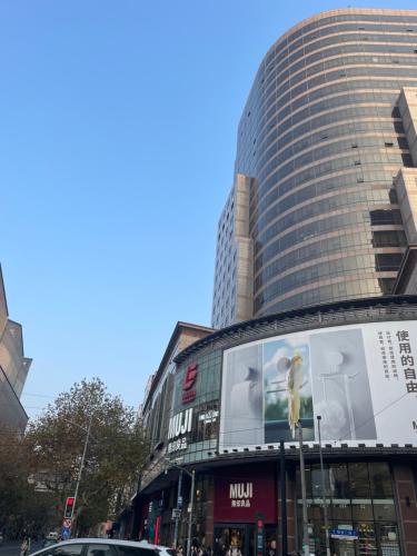 a tall building with a large billboard in front of it at Shanghai old Alleyway in Shanghai