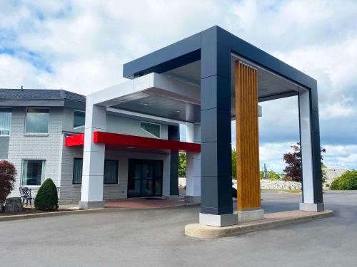 a blue and white building with a large window at Comfort Inn East in Sudbury