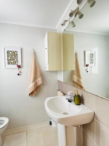 a white bathroom with a sink and a toilet at Rincón de María - Ganador Traveller Awards 2025 y 2026 in Playa de Gandia
