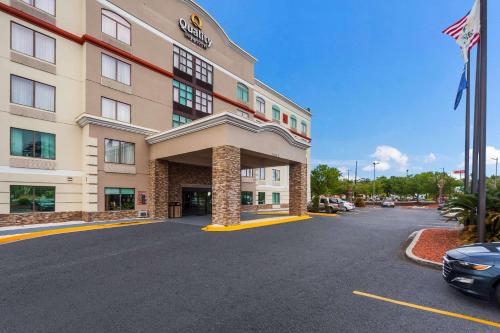 a hotel with a car parked in a parking lot at Quality Inn & Suites North Myrtle Beach in Myrtle Beach