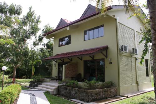 a house with a pathway in front of it at Beringgis Beach Resort & Spa in Papar