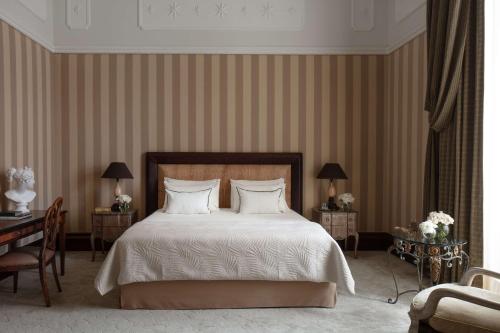 a bedroom with a large bed with white sheets and pillows at Anantara Palazzo Naiadi Rome Hotel - A Leading Hotel of the World in Rome