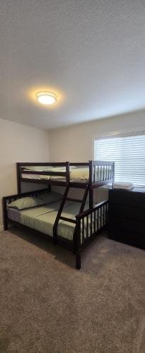 a bedroom with two bunk beds and a window at Atare Suite in Saskatoon