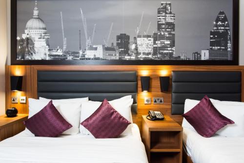 Habitación de hotel con 2 camas y un mural de la ciudad en London Court Hotel en Londres