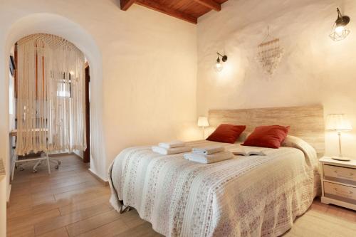 a bedroom with a bed with red pillows on it at La Vega Rural in Garachico