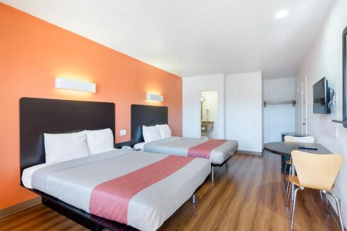 a hotel room with two beds and a desk at Motel 6-Santa Fe, NM - Downtown in Santa Fe