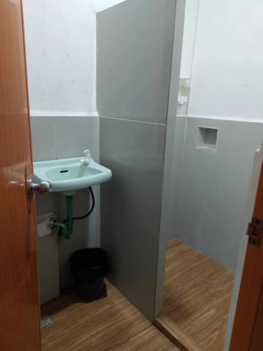 a bathroom with a sink and a toilet at Sakâ Sakâ Beach House in Sipalay