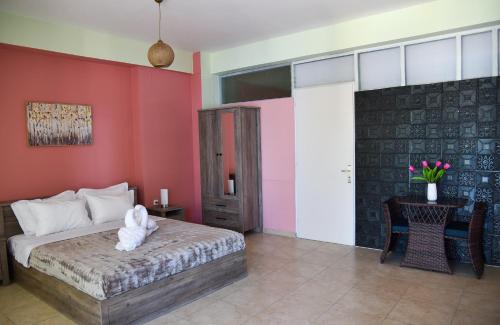 a bedroom with a bed and a red wall at ORIZONTAS Seaview Maisonette in Monodhéndrion