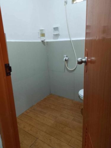 a small bathroom with a toilet in a room at Sakâ Sakâ Beach House in Sipalay