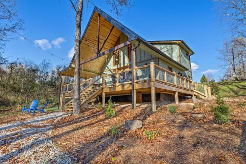a house on a hill with a blue chair at EagleRock Retreat in Rogers