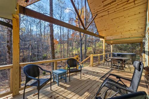 a wooden porch with chairs and a table and a grill at EagleRock Retreat in Rogers