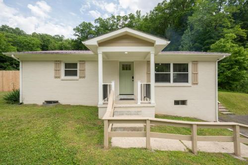 a white house with a green door and a fence at 50 Shades of Slade in Rogers