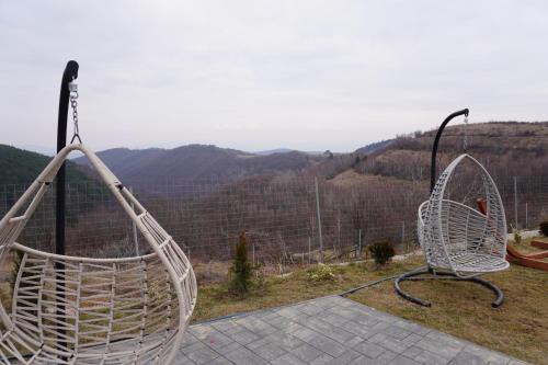 a white chair sitting on top of a hill at Cabana Brad Apuseni in Rîmeţi