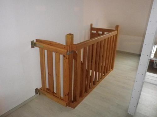 a staircase with wooden railings in a room at Charmant duplex avec belle vue mer la plage à 100 m in Saint-Nic
