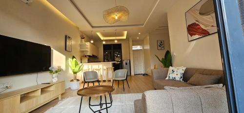 a living room with a couch and a table at BLT at Pearl Marina Estate Garuga in Entebbe
