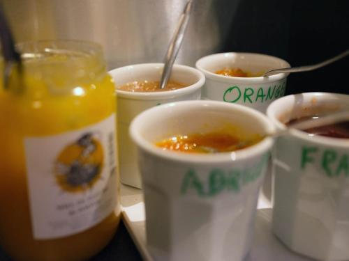 a group of four cups of food on a table at Logis Hôtel de l'Europe in Poitiers