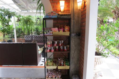 a food pantry with food on a shelf at Baan Bee Residence in Nong Prue