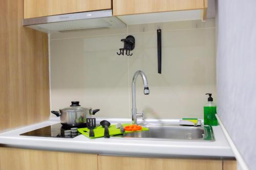 a kitchen counter with a sink and a stove at Mount Austin IKEA, AEON 10mins -Pool View- B122 in Johor Bahru