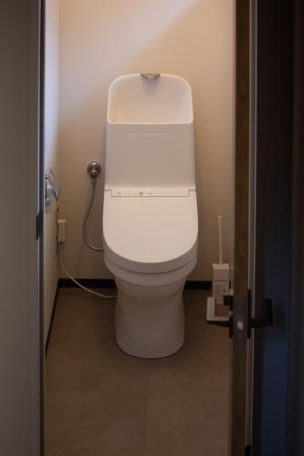 a bathroom with a white toilet in a room at TEIEN stay sauna in Ōtani