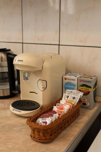 a coffee maker sitting on a counter next to a basket of milk at Neuhausz Residenz Ultra-Central Apartment in Timişoara