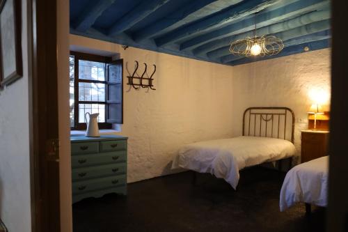 a bedroom with two beds and a window at Casa Rural El Ayozar in Albanchez de Magina