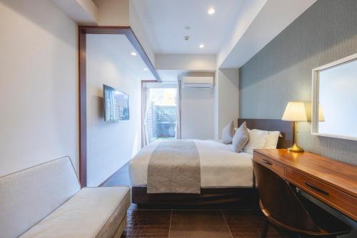 Ένα ή περισσότερα κρεβάτια σε δωμάτιο στο Centurion Hotel Residential Akasaka Station