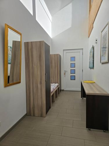 a hallway with a desk and a mirror on a wall at Apartment im Salzburger Seenland in Seeham