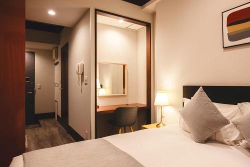 Ένα ή περισσότερα κρεβάτια σε δωμάτιο στο Centurion Hotel Residential Akasaka Station