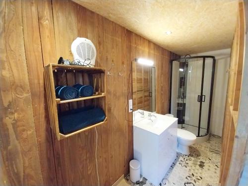a bathroom with a sink and a toilet at L'Eglantine in Rochefort