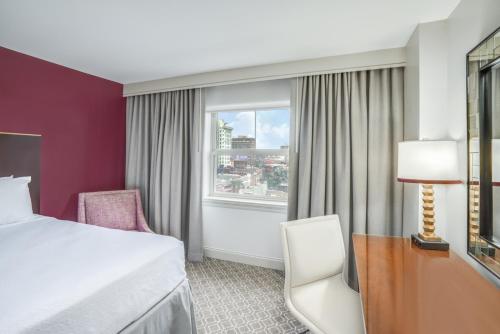 a hotel room with a bed and a window at Crowne Plaza New Orleans French Qtr - Astor by IHG in New Orleans