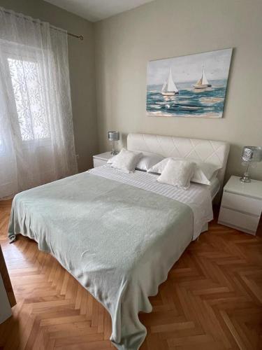 a bedroom with a large white bed with two sails at Villa Norah in Podgora