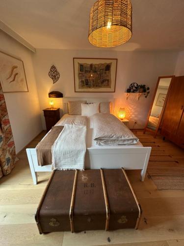 a bedroom with a bed and a table and lights at apARTmentT2 in Zams