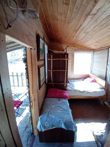 a small bed in the inside of a tiny house at CASA Petra in Bituše