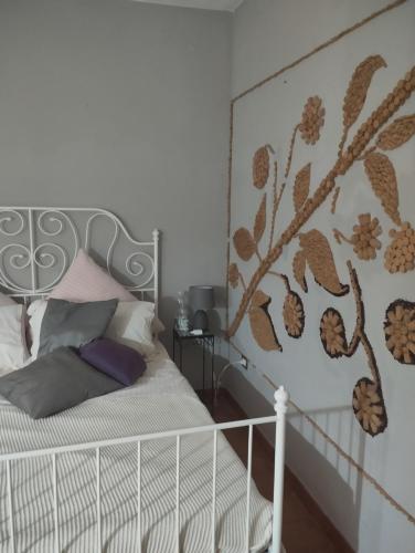 a bedroom with a white bed with a metal headboard at Al Passo di Thalia in Ricadi