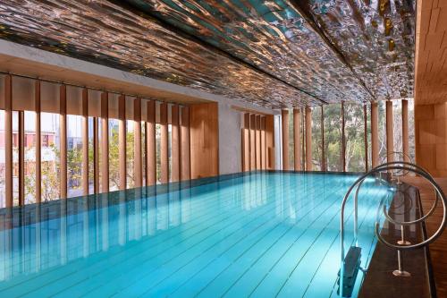 a swimming pool with windows and a ceiling at The St. Regis on the Bund, Shanghai in Shanghai