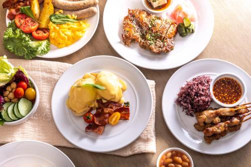 a group of plates of food on a table at Carlton Hotel Bangkok Sukhumvit in Bangkok