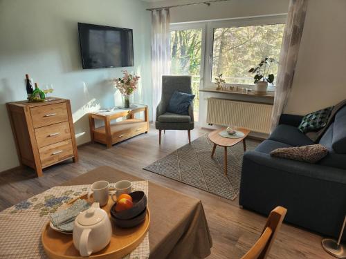 a living room with a couch and a table at Winzerhof Düring in Iphofen
