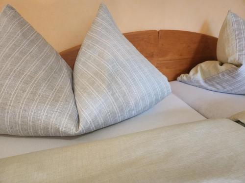 two pillows sitting on top of a bed at Winzerhof Düring in Iphofen